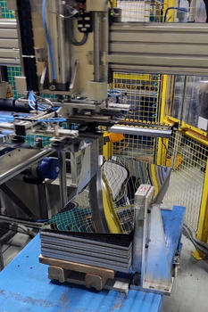 Magnetic sheet separator MC spreads apart the upper sheets of the stack